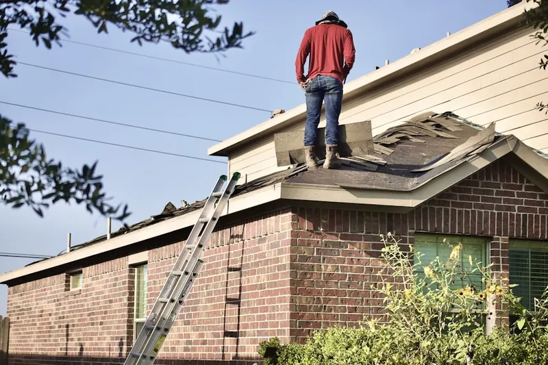 Professional roofer working on a residential roof in Palomino Farms
